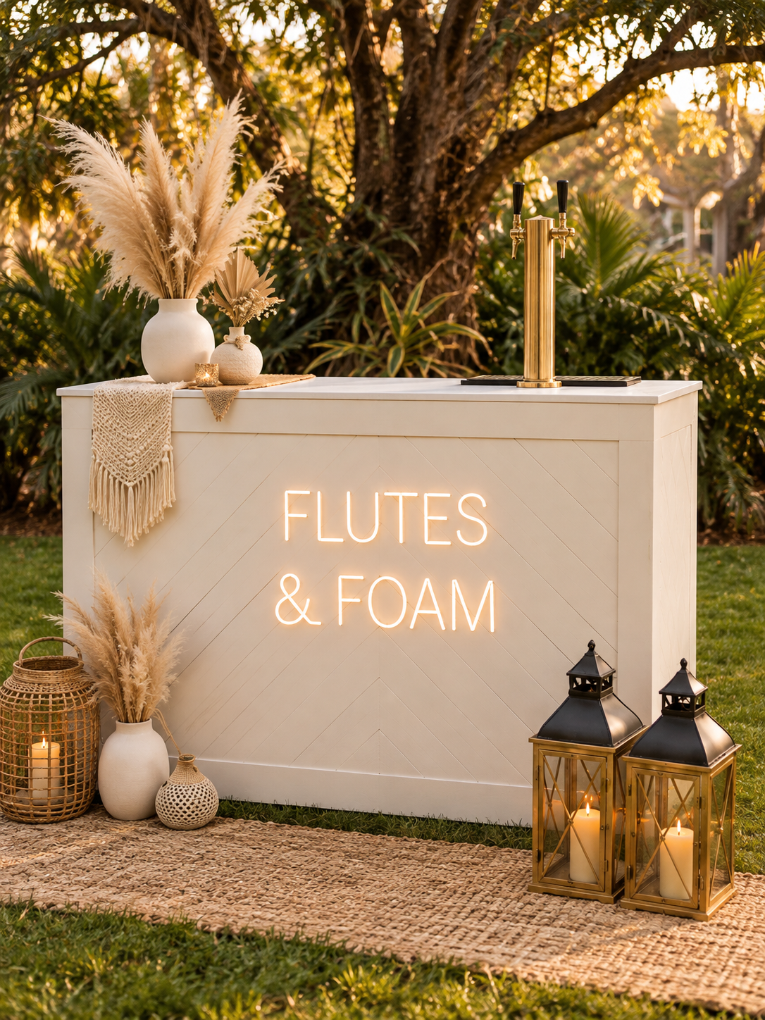 Ivory Flutes & Foam bar with pampas grass, brass taps and lanterns